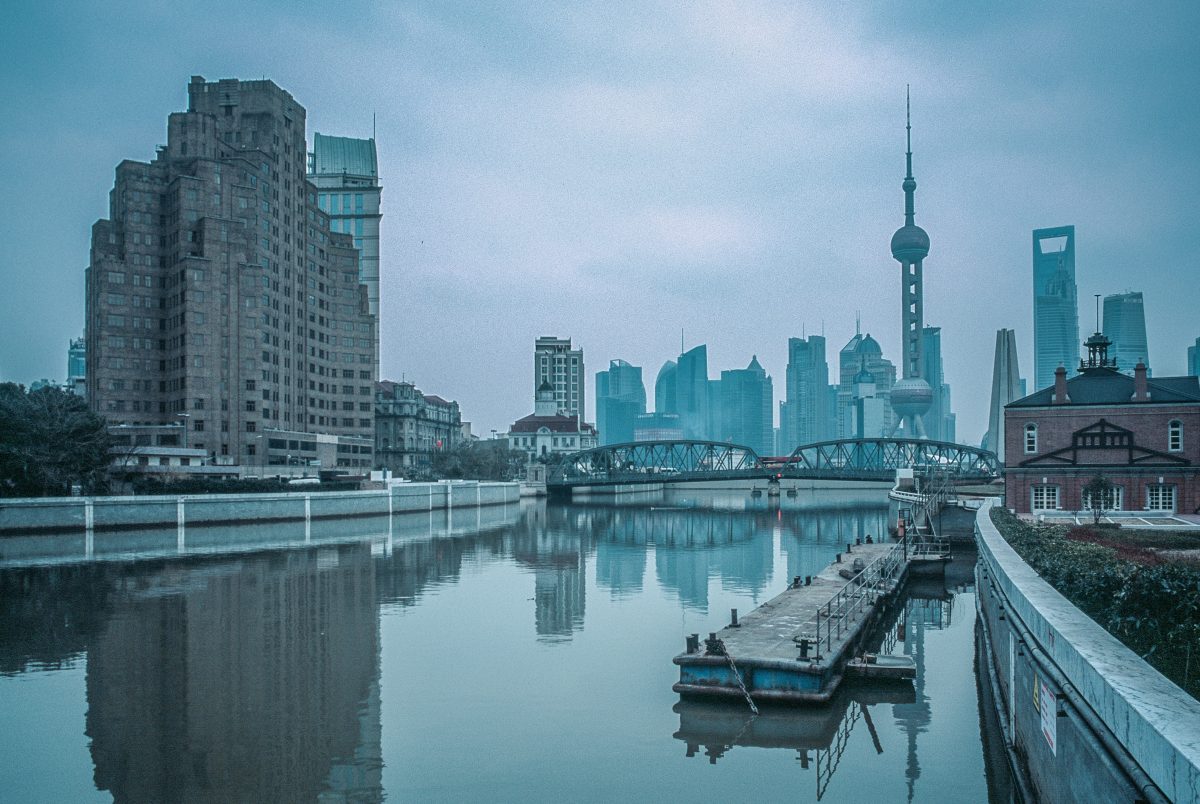 Waterfront view of The Bund during a foggy day with many iconic landmarks in sight Waterfront view of The Bund during a foggy day with many iconic landmarks in sight