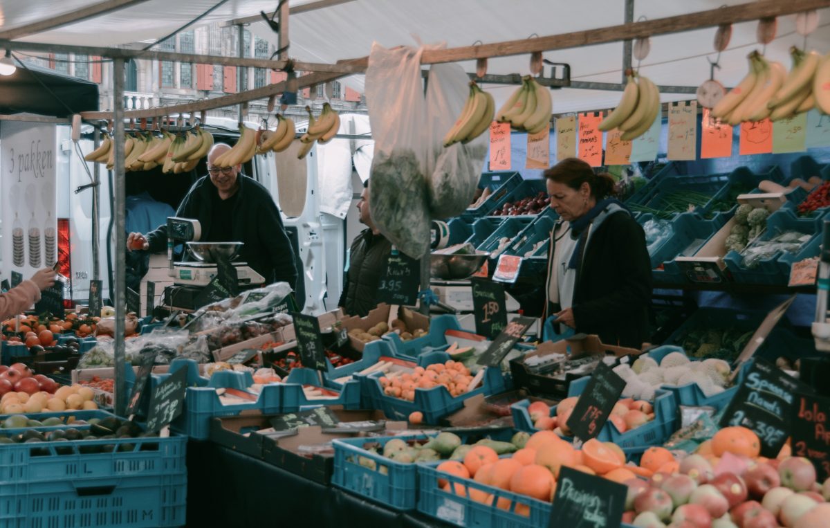 A weekend market depicting vendors selling fresh produce