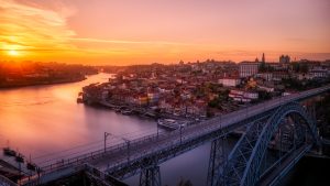 Awesome sunset shot of Porto’s skyline with the icons Dom Luis Bridge, Duoro River and Cais da Ribeira featured