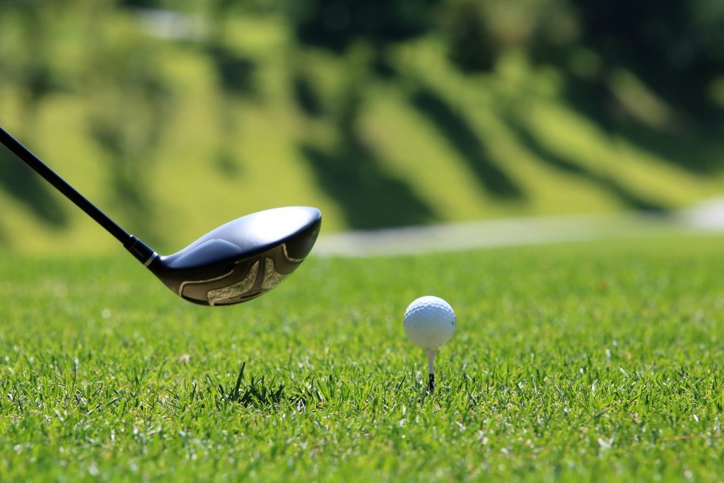 Golfing on green fairway