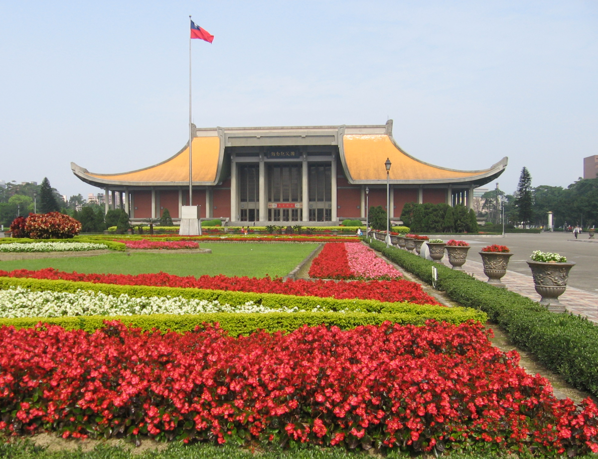 Courtyard of the Sun Yat-sen Memorial Hall with a beautiful garden filled with red flowers