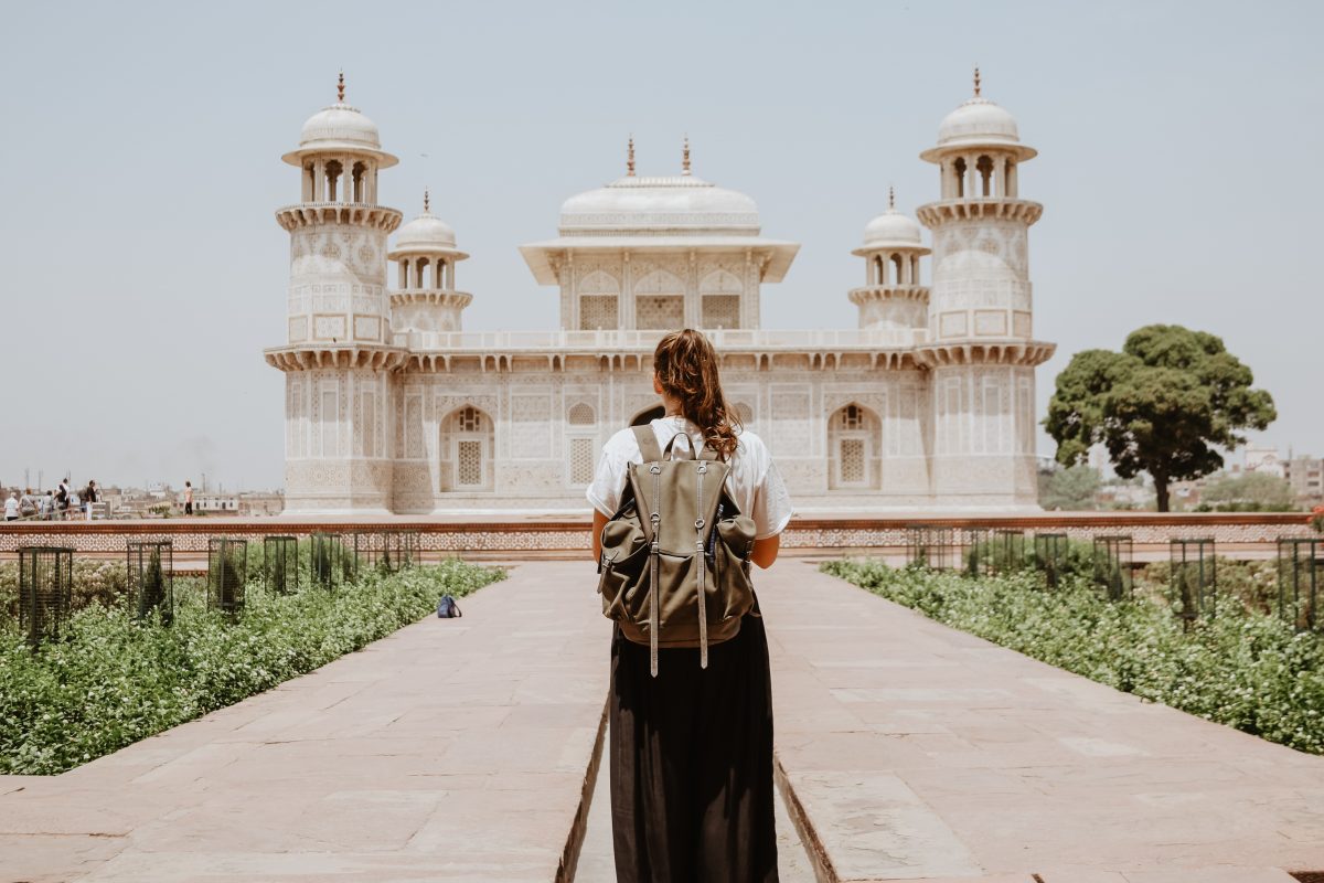 Woman standing with her travelling backpack Woman standing with her travelling backpack