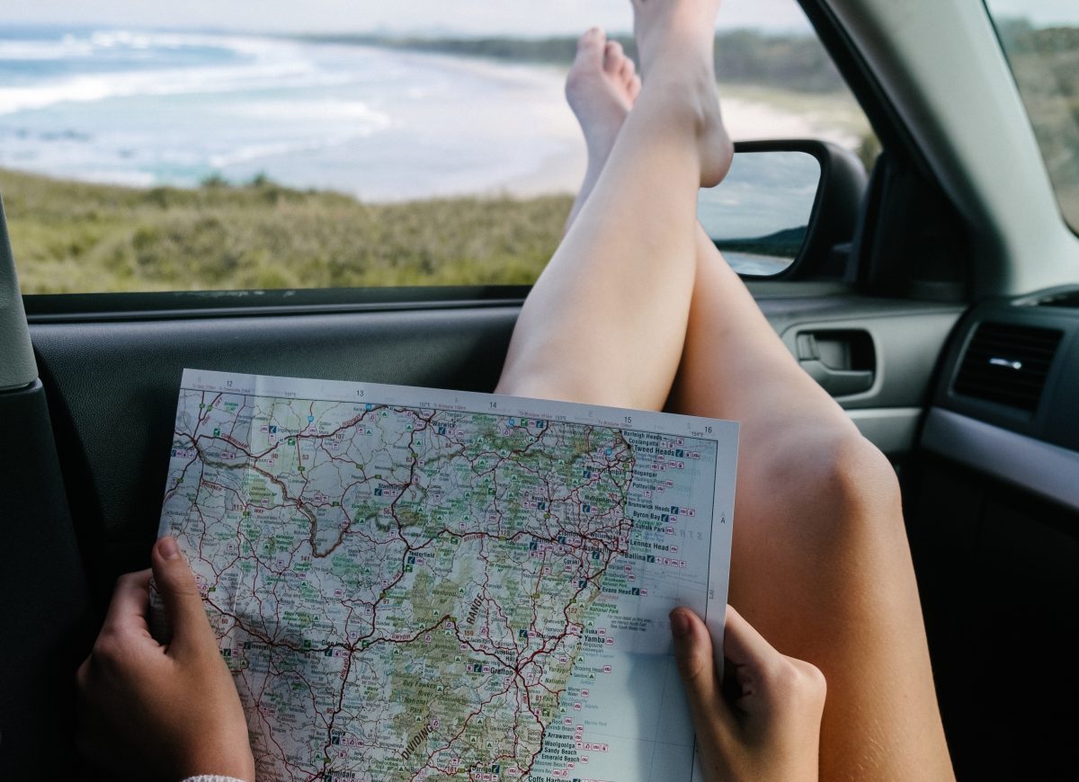 Figure reading map in the car while travelling Figure reading map in the car while travelling