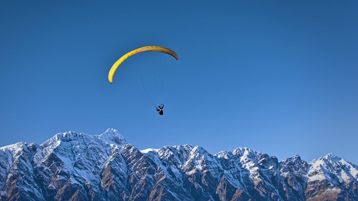 Figure paragliding over the mountains Figure paragliding over the mountains