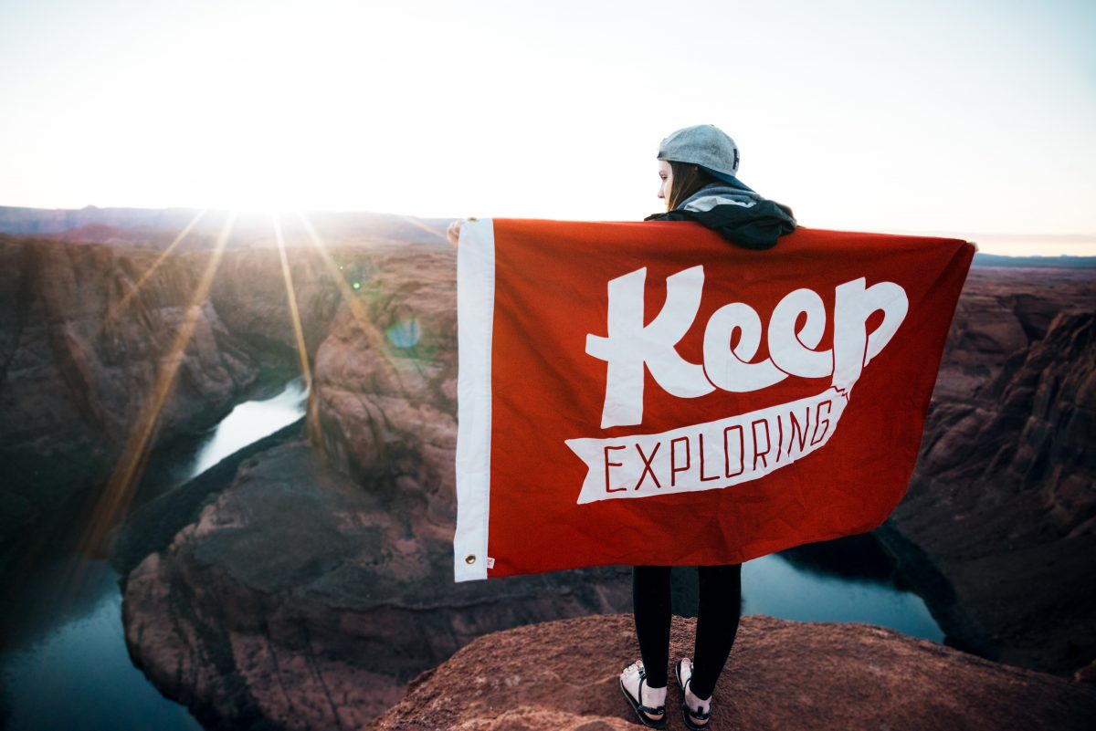 Woman holding a flag on a mountain Woman holding a flag on a mountain