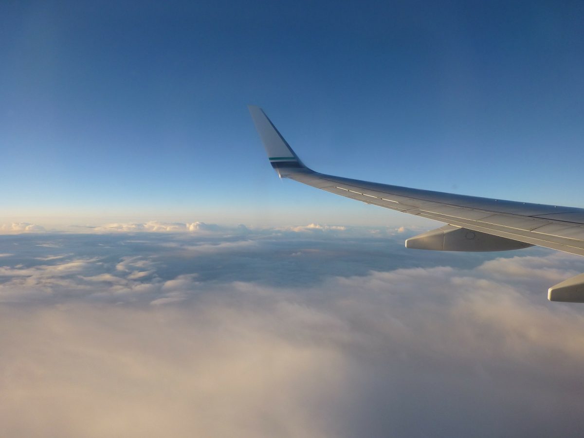 airplane wing above clouds