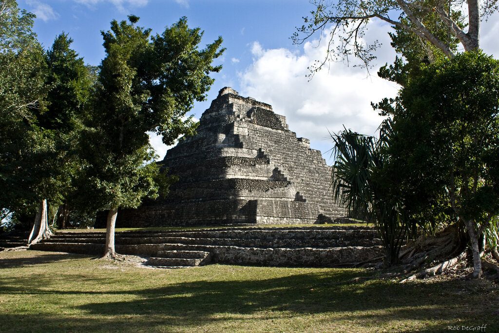 View of Temple to the Sun god surrounded by trees at Chacchoben ruins