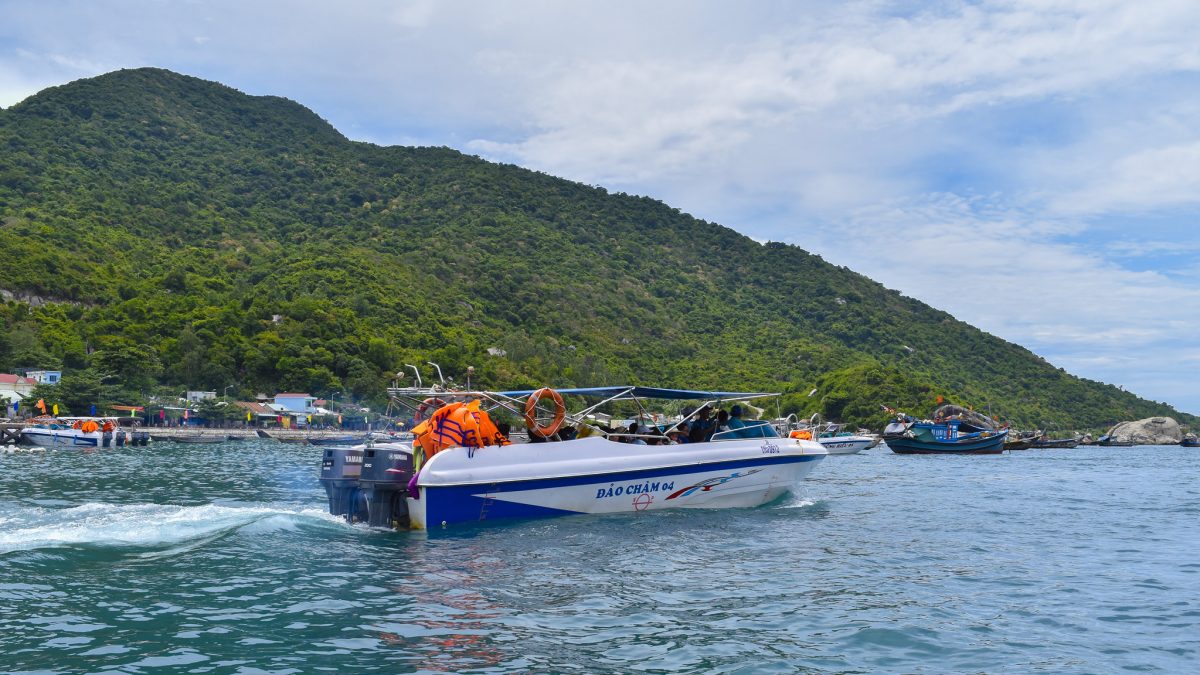 A boat speeds through the water in Cu Lao Cham