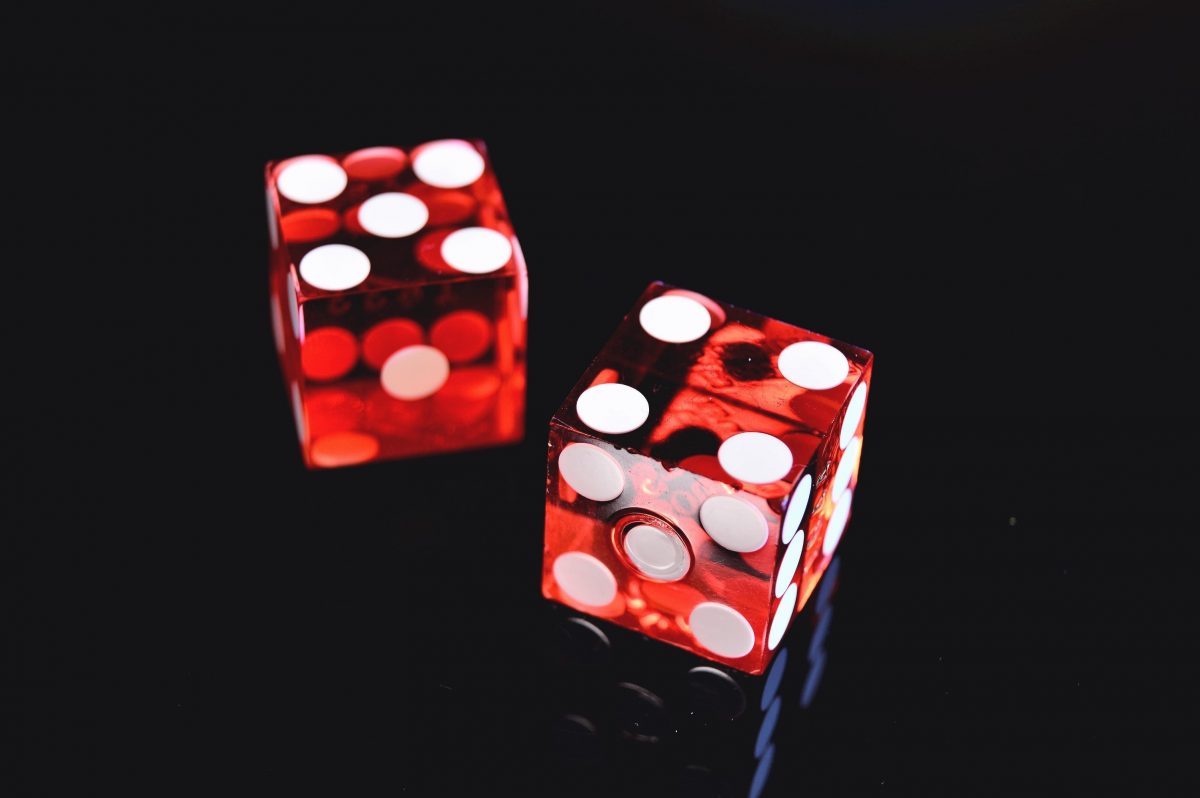 2 red dices on black background