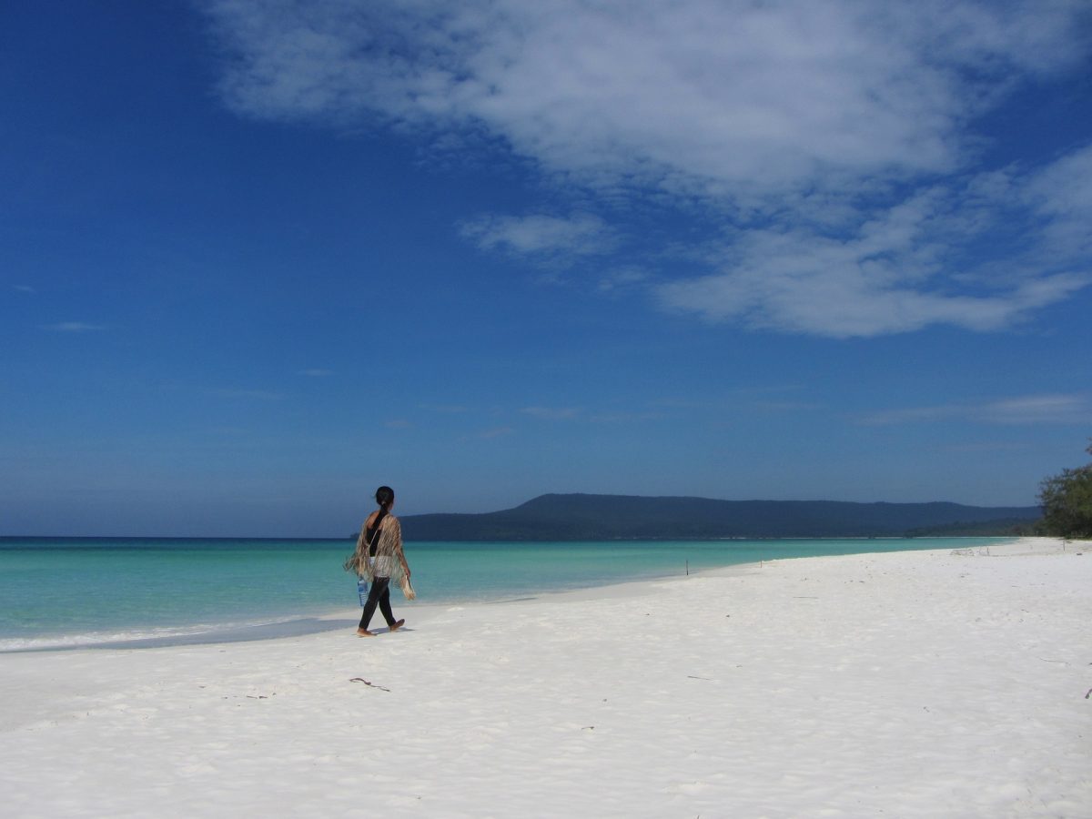 A woman walks on the beach in Koh Rong Island, Cambodia