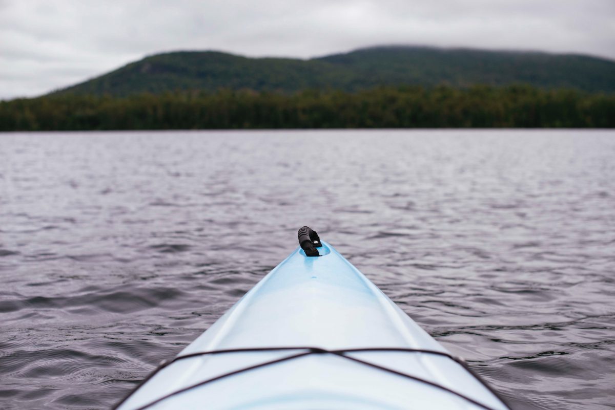 Tip of a kayak on water