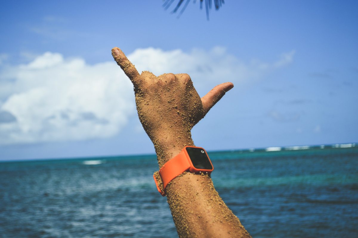 Person doing hand sign on the beach