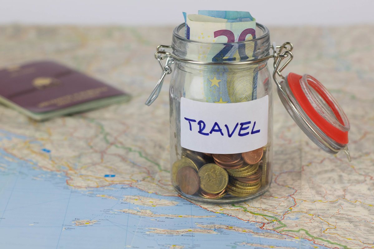 saved travel money on a small job sitting atop a world map saved travel money on a small job sitting atop a world map