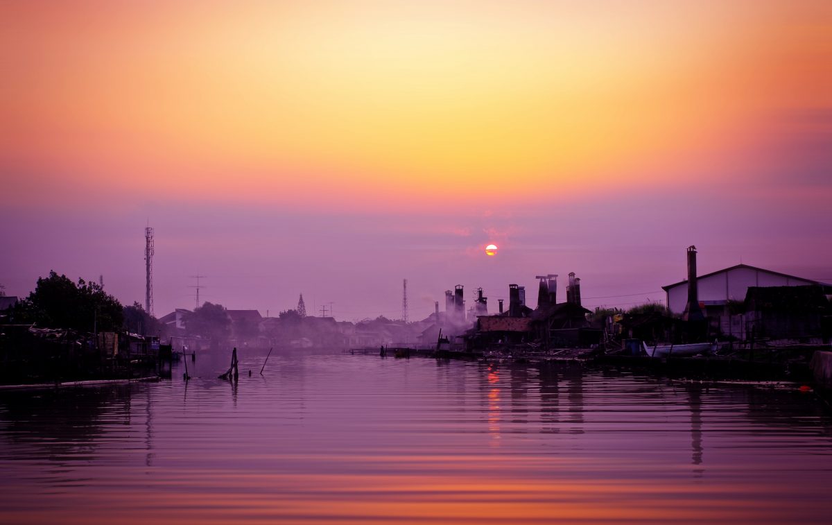 Semarang city during the sunset over the river in a fishing village