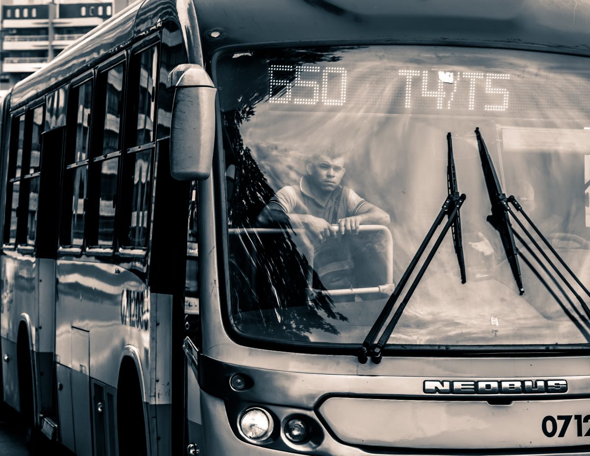 Grayscale photo of man inside bus