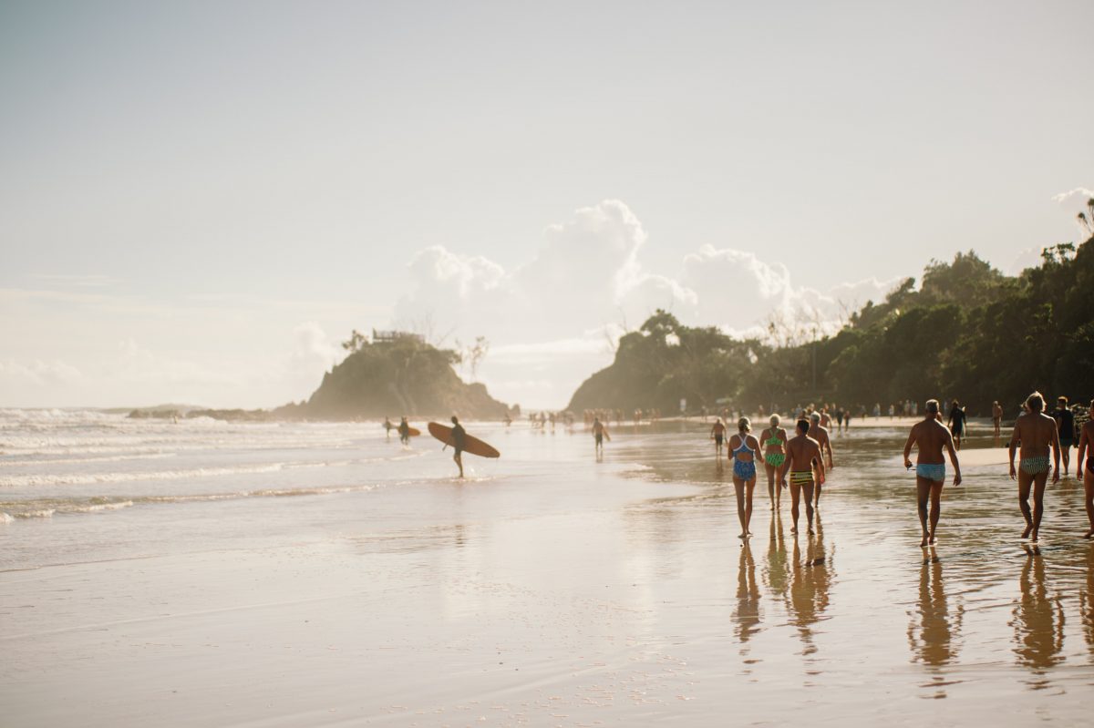 surfers getting ready to surf at Byron Bay australia during summer time surfers getting ready to surf at Byron Bay australia during summer time