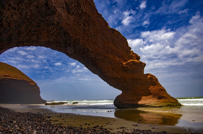 View of the stone arch in the day at Legzira beach, Morocco