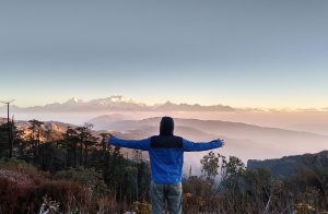 A man standing on mountain during daytime