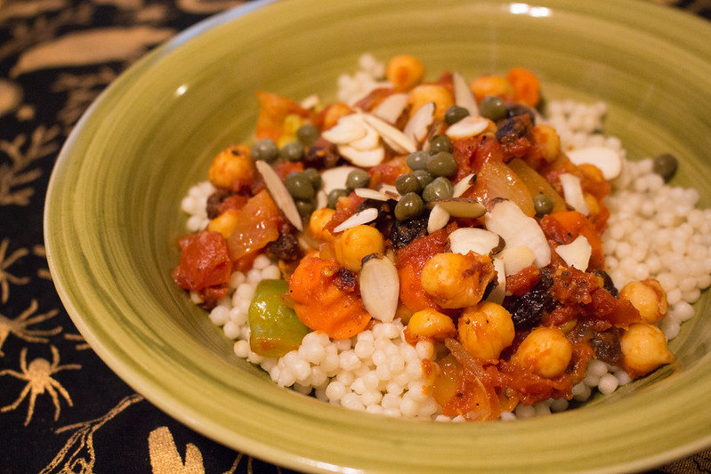 Moroccan couscous with chickpeas served in a green plate