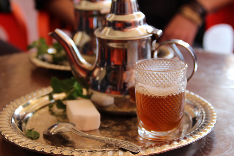 Moroccan mint tea served with a sugar cube over a silver plate