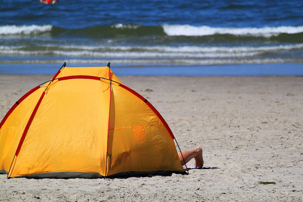 Orange beach tent on the sandy beach