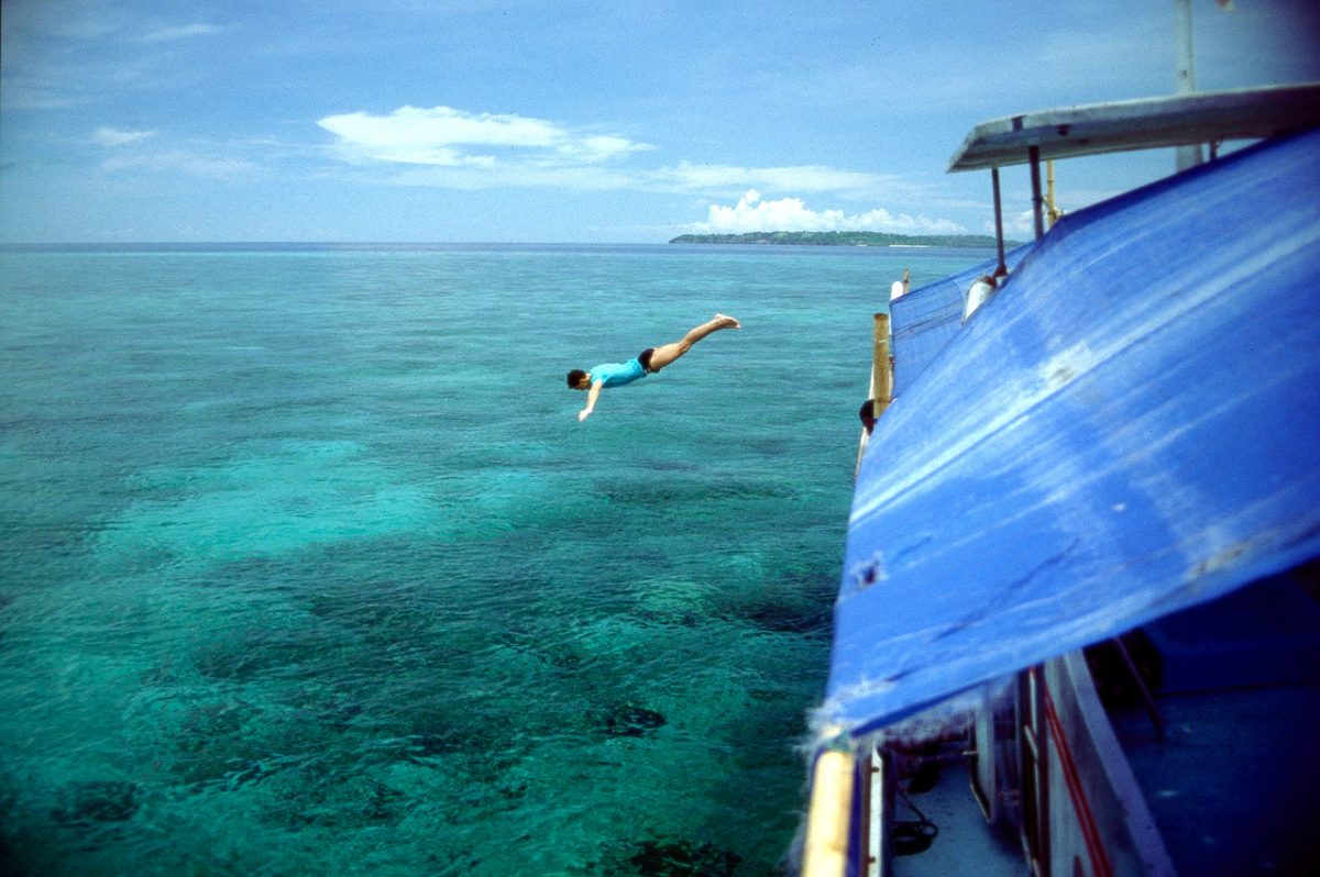 man diving for marine life in wakatobi island indonesia