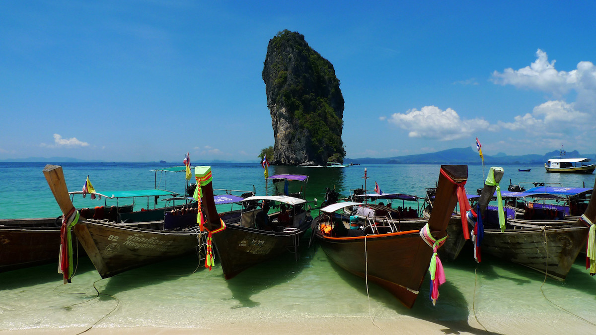 boats are in line ready to go island hopping from Ao Nang beach, Thailand