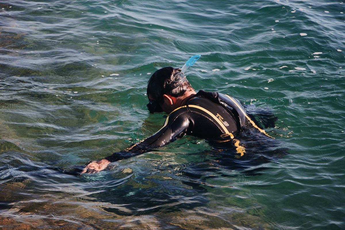 Man snorkelling in the sea with snorkelling gears Man snorkelling in the sea with snorkelling gears