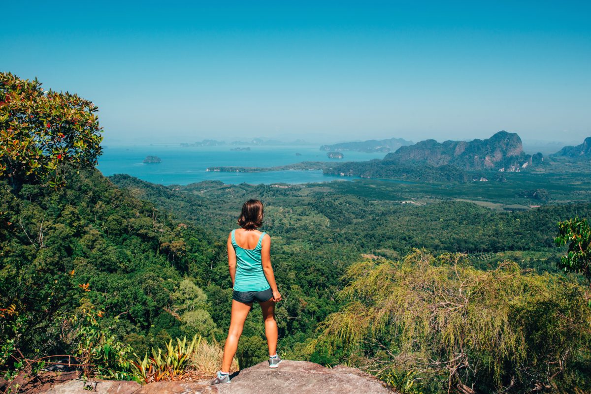 Girl standing on the view poinf of the mountain, Tab Kak Hang Nak Nature Trail, Thailand