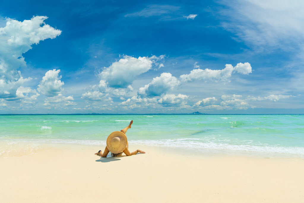 Woman sunbathing alone on a beach in Jamaica