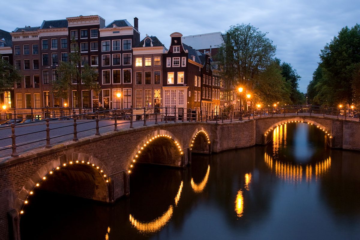 Nighttime photo of Amsterdam's canals with beautiful fairy lights Nighttime photo of Amsterdam's canals with beautiful fairy lights