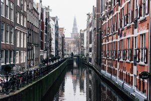 Long shot photo of Amsterdam's canals, with beautiful background buildings