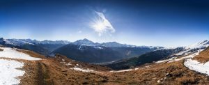 sun shining brightly on the snow-covered mountains of the French Alps