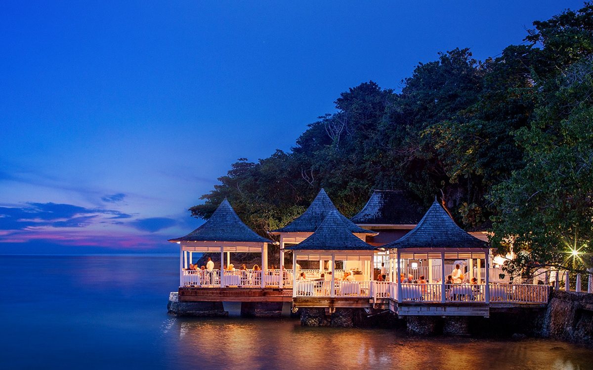 Couples Tower Isle Resort shines brightly during the evening as visitors dine.