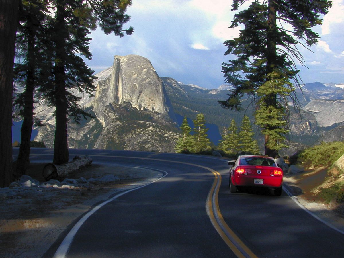 Red car trailing the road to Glacier Point