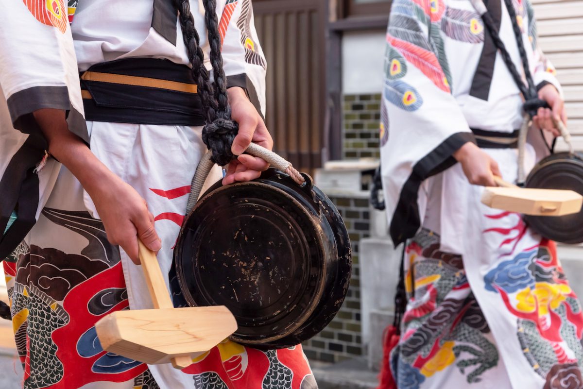 Full traditional Japanese attire with local drum during a parade in Shibuya