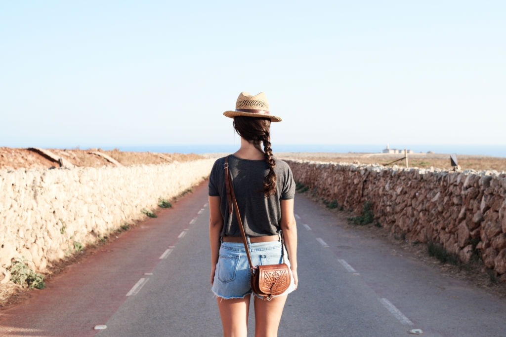 Women traveling with brown mini travel purse