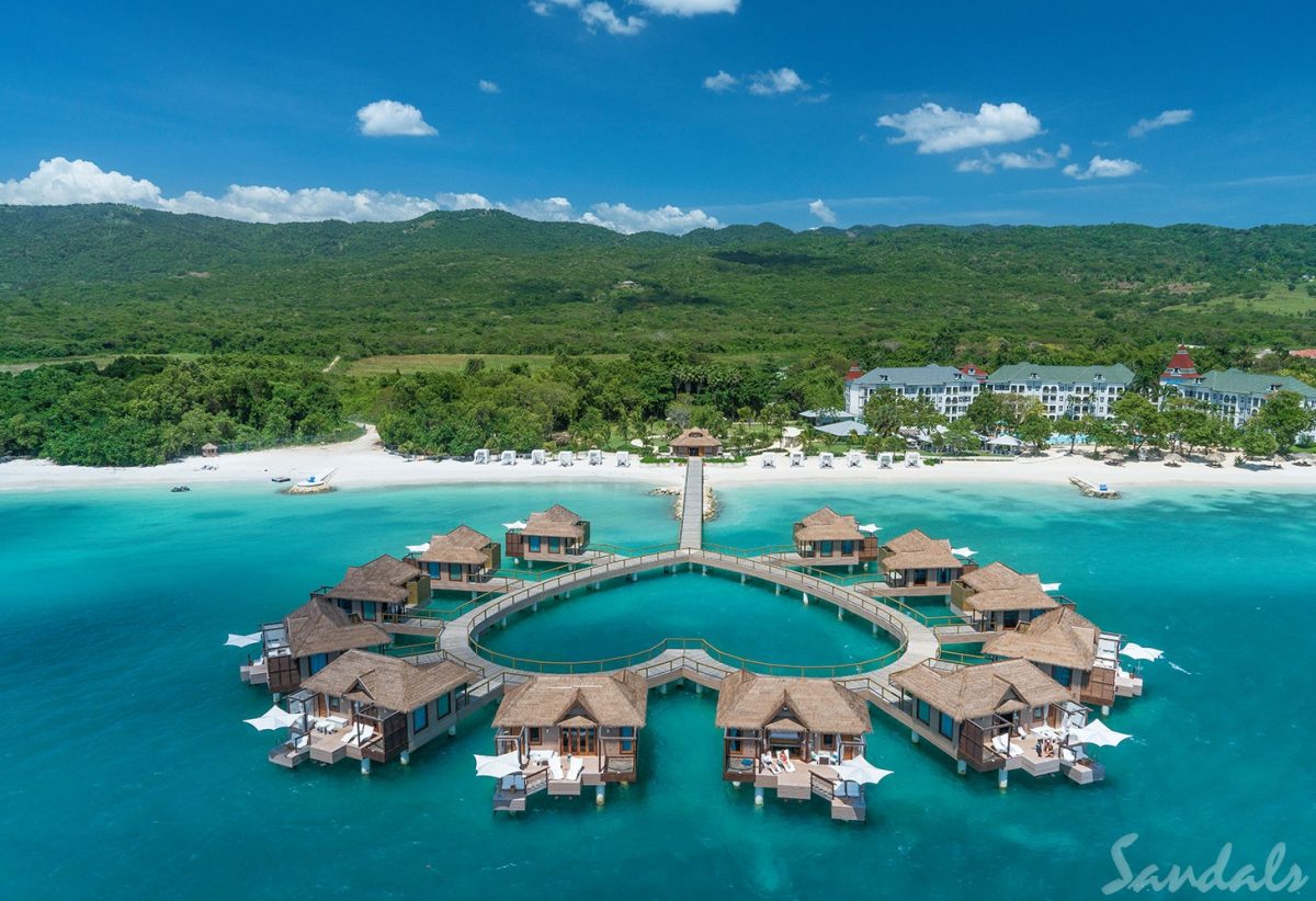 heart shaped bridge connecting floating villas to the resort