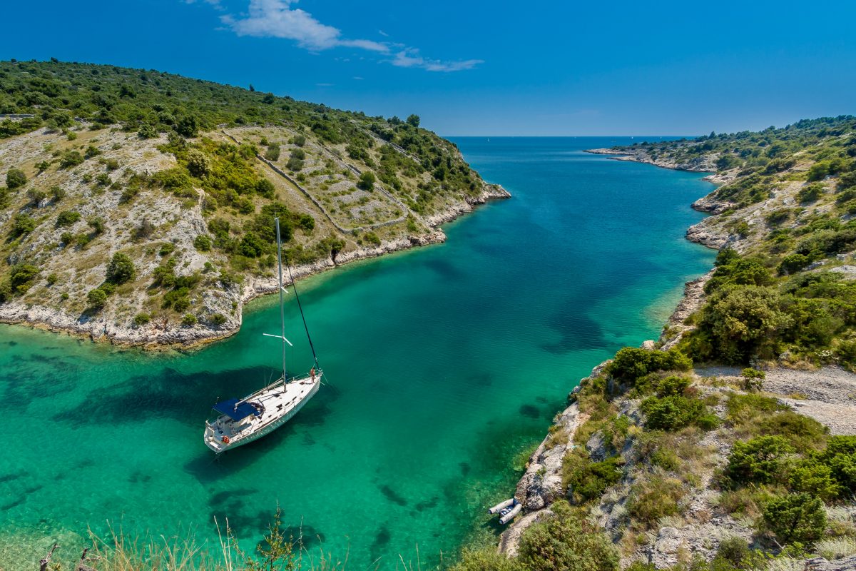 A sailing yacht passes through Trogir, Croatia