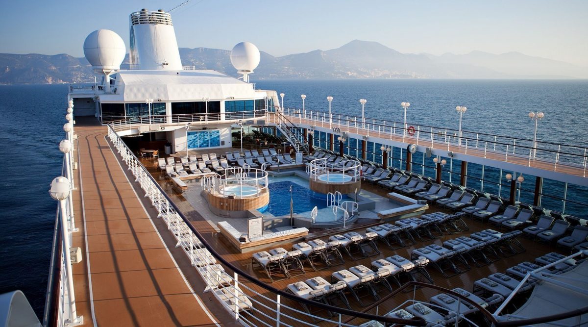 Lounge chairs surround the pool at the roof deck of Bliss Cruise's Spain/Morocco Voyage ship at sea