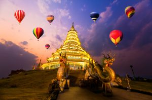 Hot-air balloons flying over Wat hyua pla kang , Chiang Rai, Thailand