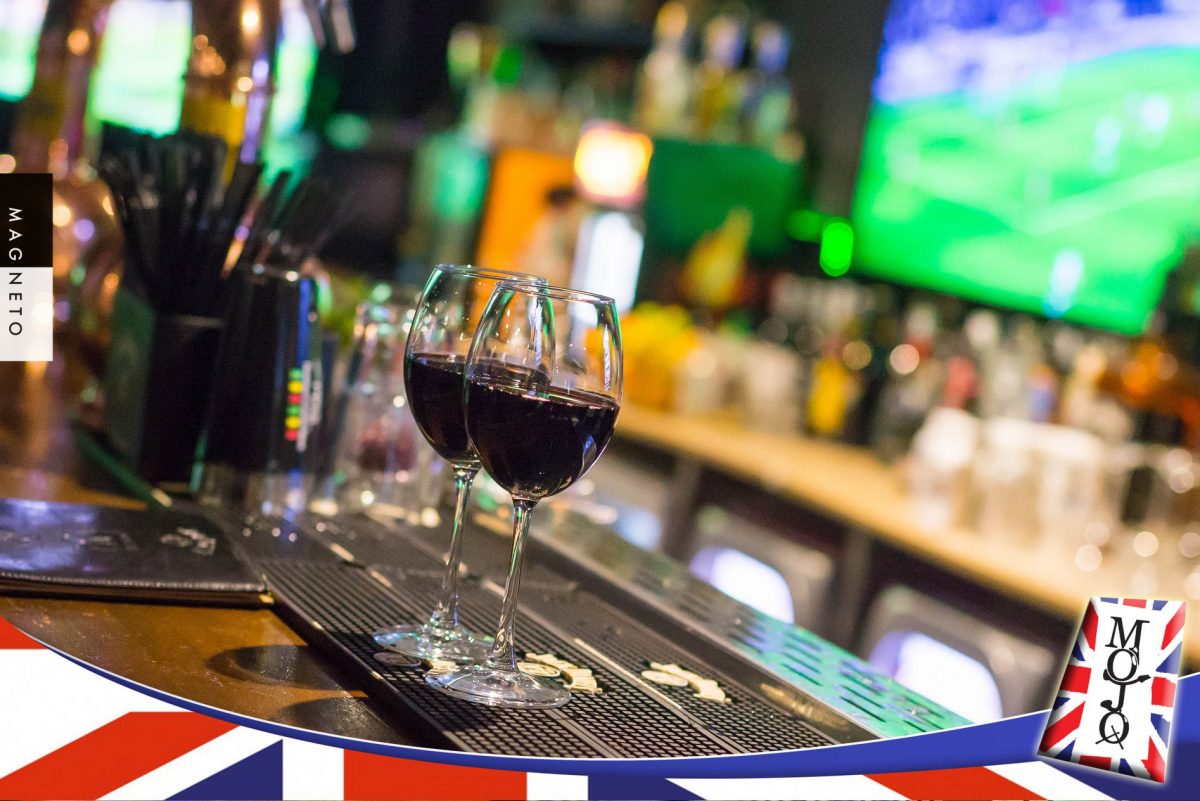 two glasses of wine sit atop a bar at Mojo Music Club