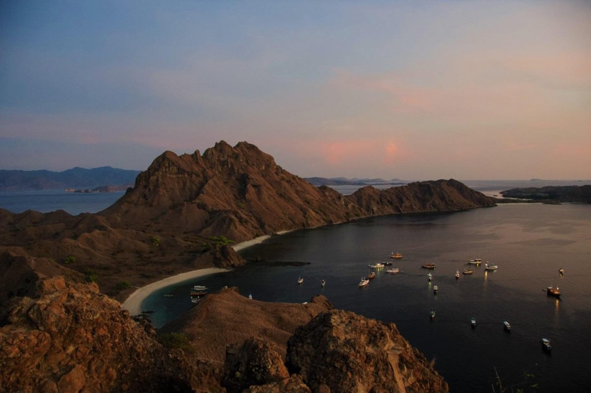 ariel photo of yachts on the shore of Komodo Island Indonesia ariel photo of yachts on the shore of Komodo Island Indonesia