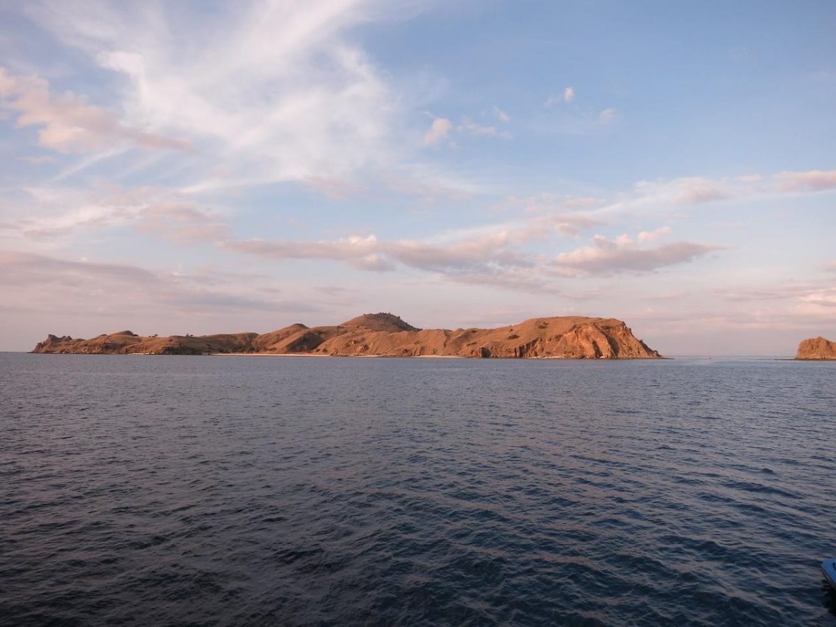 a wide angle shot of Komodo Island from far away a wide angle shot of Komodo Island from far away