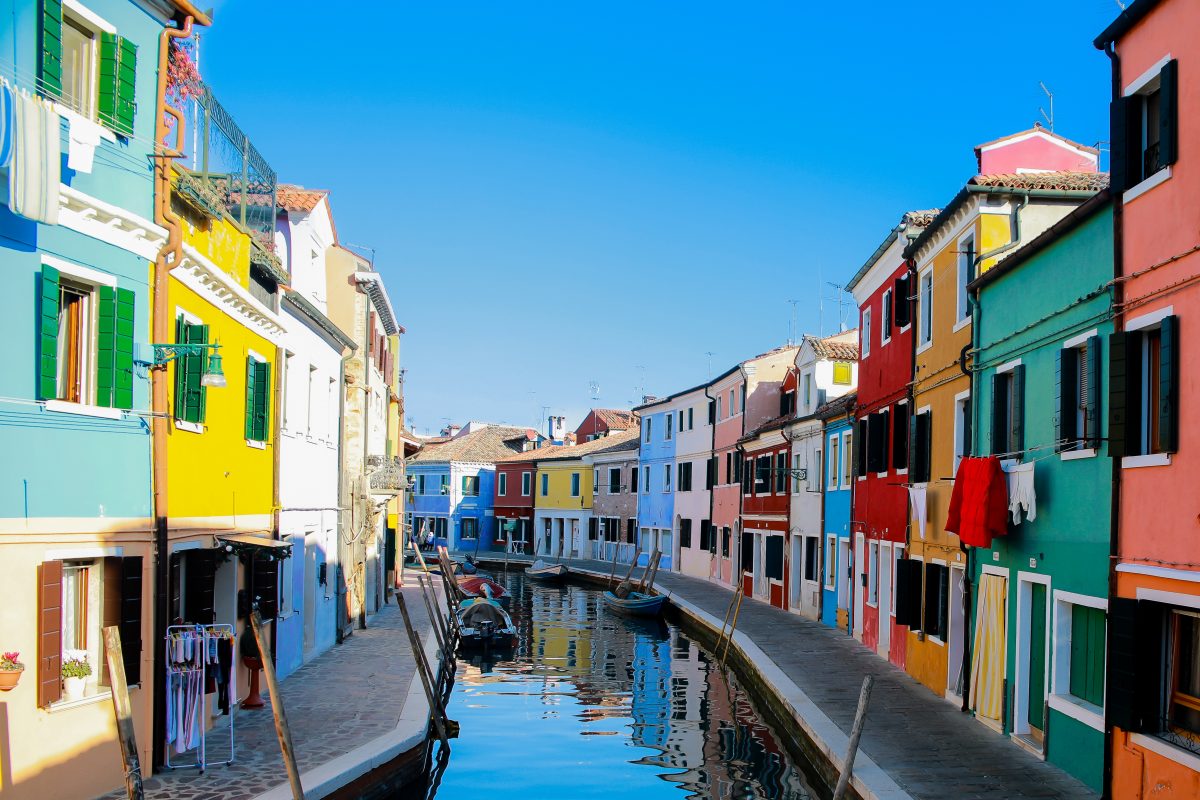 A canal street in Burano Venice with colorful buildings A canal street in Burano Venice with colorful buildings
