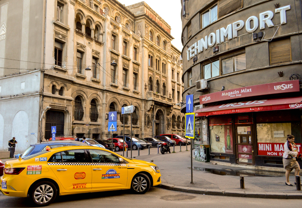 Taxis and cars line outside the Tehnoimport Building in Bucharest, Romania