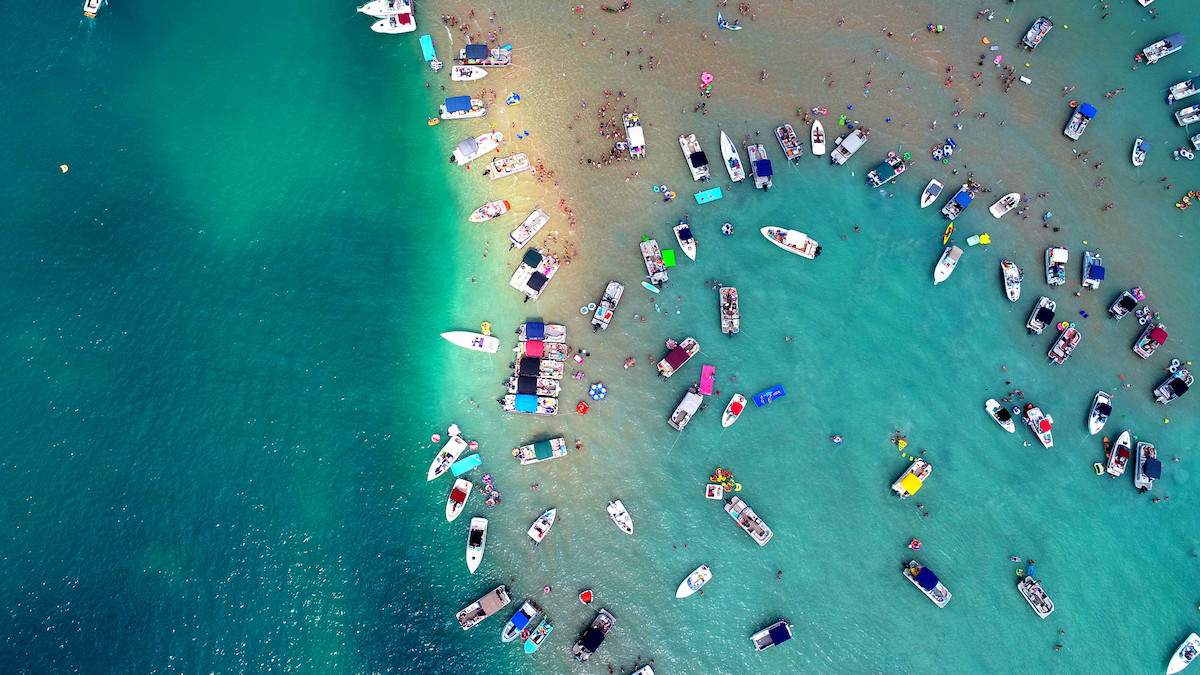 Colorful boats dotting the legendary sandbar of Torch Lake, Michigan Colorful boats dotting the legendary sandbar of Torch Lake, Michigan
