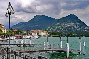 wide angle shot of the mountains and lake at Lugano Switzerland