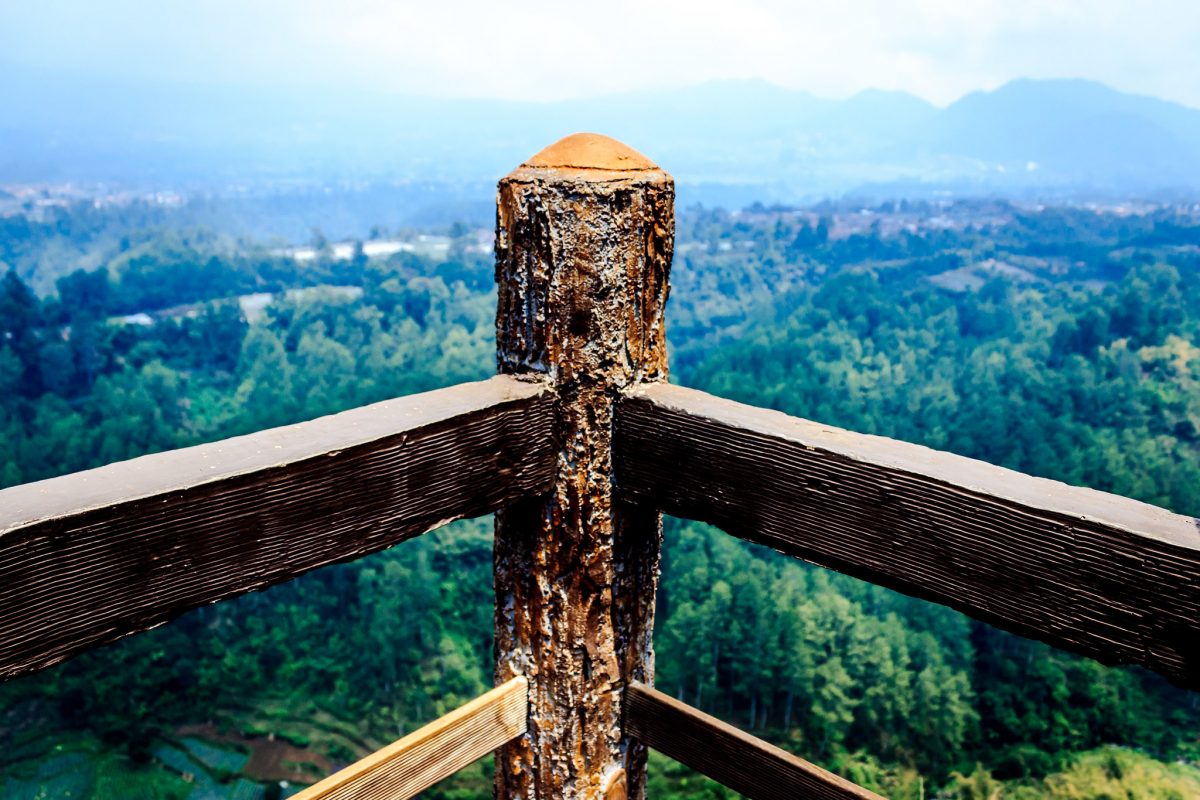 The corner of a fence overlooks the view from atop Tebing Keraton in Bandung, Indonesia