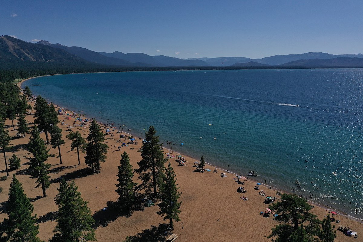 Tourists line up the long stretch of Nevada Beach shoreline